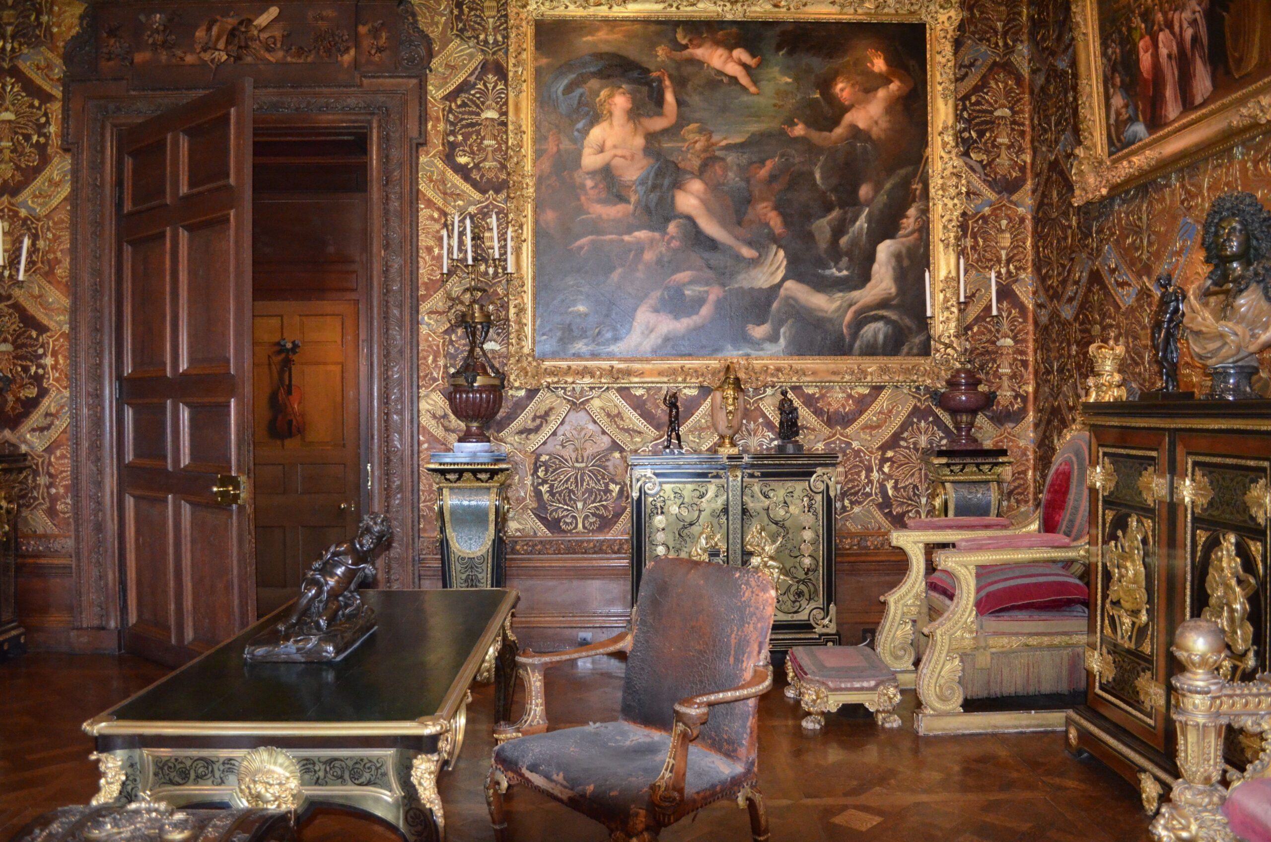 Luxurious room featuring vintage furnishings, classic art, and ornate decorations.