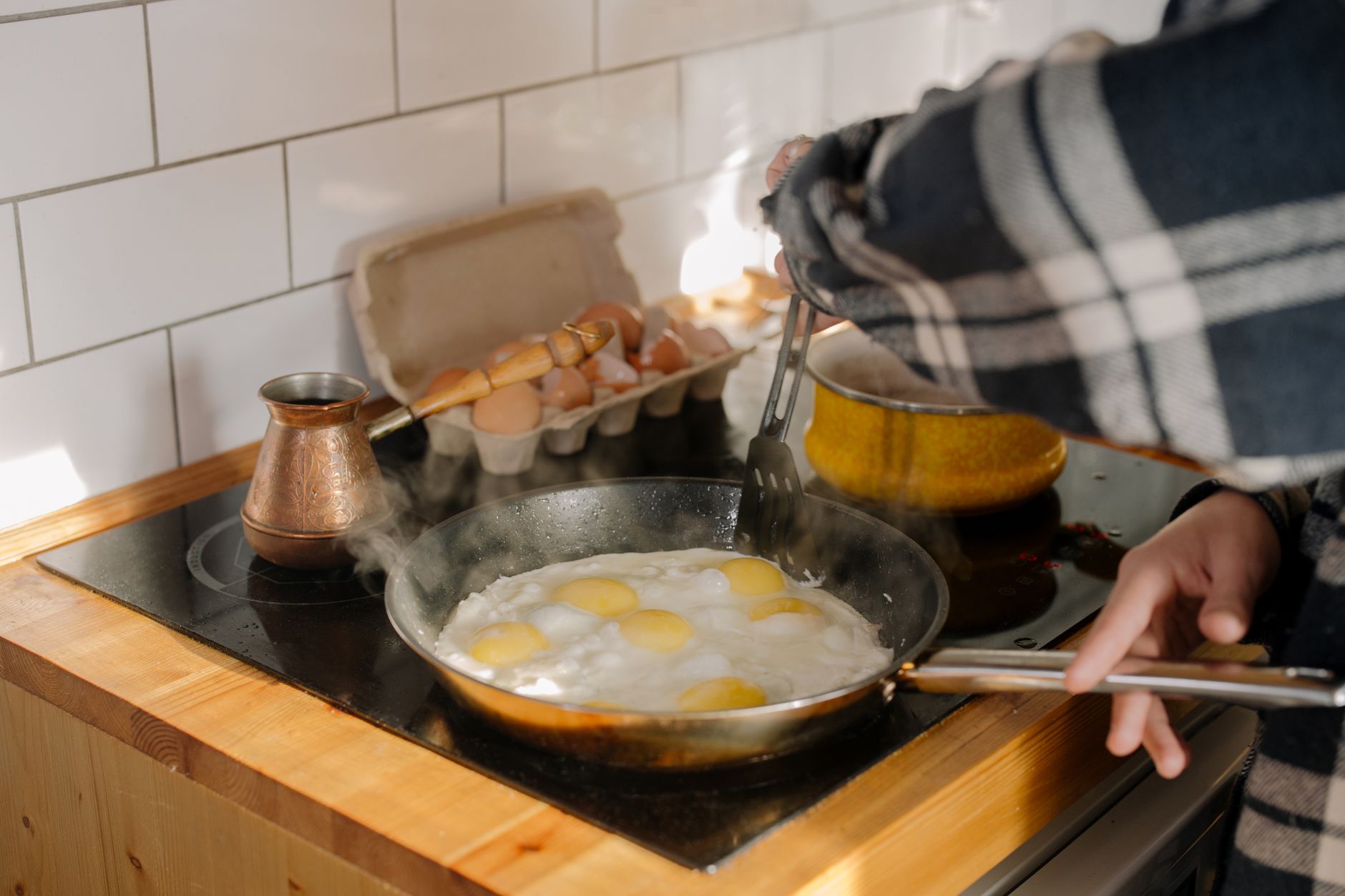 Fluffy scrambled eggs being cooked in a pan